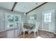 Dining area features neutral decor, modern lighting, wood flooring, and doors leading to the backyard at 6201 Sellars Ct, Charlotte, NC 28211