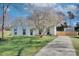 Charming home with a well-manicured lawn, beautiful tree, and a long driveway, creating inviting curb appeal at 6201 Sellars Ct, Charlotte, NC 28211