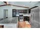 Modern kitchen featuring stainless steel appliances, dark cabinets, a granite countertop island and wood look flooring at 6201 Sellars Ct, Charlotte, NC 28211