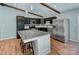 Contemporary kitchen boasts granite countertops, stainless steel appliances, dark cabinetry, and a functional center island at 6201 Sellars Ct, Charlotte, NC 28211