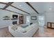 Spacious living room with exposed beams, a fireplace, and a comfortable sofa, perfect for relaxing and entertaining at 6201 Sellars Ct, Charlotte, NC 28211