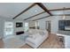 Open-concept living room featuring exposed beams, a sectional sofa, and views of the kitchen and backyard at 6201 Sellars Ct, Charlotte, NC 28211