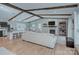 Open-concept living room with exposed beams, a fireplace, and a seamless transition to the dining area and kitchen at 6201 Sellars Ct, Charlotte, NC 28211