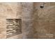 Tiled shower with built in shelving and modern fixtures at 6201 Sellars Ct, Charlotte, NC 28211