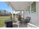 Covered back porch with patio furniture and string lights at 650 Scotch Meadows Loop, Monroe, NC 28110