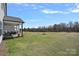 Large backyard featuring a covered porch, perfect for outdoor gatherings, with ample space for recreation at 650 Scotch Meadows Loop, Monroe, NC 28110