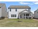 Backyard view featuring a covered patio, perfect for outdoor seating, with a grassy area at 650 Scotch Meadows Loop, Monroe, NC 28110