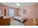 Cozy bedroom with a twin bed, natural light from the window, and light pink walls at 650 Scotch Meadows Loop, Monroe, NC 28110
