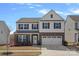 Charming two-story home features a brick and siding facade with a two-car garage and manicured landscaping at 650 Scotch Meadows Loop, Monroe, NC 28110