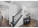 Bright foyer with dark-stained staircase, wood flooring, and access to other rooms at 650 Scotch Meadows Loop, Monroe, NC 28110