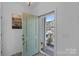 Inviting foyer with a light green door and a view of the neighborhood at 650 Scotch Meadows Loop, Monroe, NC 28110