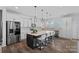 Bright kitchen featuring white cabinets, stainless steel appliances, and a large center island at 650 Scotch Meadows Loop, Monroe, NC 28110
