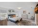 Bright main bedroom features neutral walls, carpet, natural light, and stylish decor at 650 Scotch Meadows Loop, Monroe, NC 28110