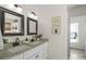 Bright bathroom with granite countertop, double sinks, updated fixtures, and decorative wall art at 6645 Allness Glen Ln, Charlotte, NC 28269