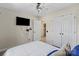 Cozy bedroom featuring a ceiling fan, a wall-mounted television, and a spacious closet at 6645 Allness Glen Ln, Charlotte, NC 28269