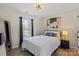 Comfortable bedroom featuring a window with curtains, a dresser, and a nightstand with lamp at 6645 Allness Glen Ln, Charlotte, NC 28269