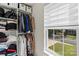 Organized walk-in closet with shelving and hanging space, view to outside at 6645 Allness Glen Ln, Charlotte, NC 28269