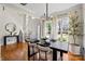 Elegant dining room with modern light fixture, hardwood floors, and large windows at 6645 Allness Glen Ln, Charlotte, NC 28269
