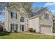 Charming two-story home with a well-maintained lawn, arched windows, and a two-car garage at 6645 Allness Glen Ln, Charlotte, NC 28269