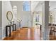 Inviting foyer with hardwood floors, staircase, and natural light from a high window at 6645 Allness Glen Ln, Charlotte, NC 28269