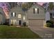 Charming two-story home featuring classic design elements and a well-manicured lawn at 6645 Allness Glen Ln, Charlotte, NC 28269