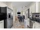 Spacious kitchen with stainless steel appliances, island with seating, and view of the living room at 6645 Allness Glen Ln, Charlotte, NC 28269