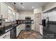 Kitchen featuring stainless steel appliances, white cabinets, and access to pantry at 6645 Allness Glen Ln, Charlotte, NC 28269