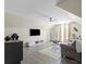 Open-concept living area with a ceiling fan, hardwood floors, a gray sofa, and modern decor at 6645 Allness Glen Ln, Charlotte, NC 28269