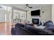Bright, open-concept living room with fireplace, hardwood floors, and view of dining area at 6645 Allness Glen Ln, Charlotte, NC 28269