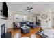 Comfortable living room featuring hardwood floors, fireplace, and an open layout to the kitchen at 6645 Allness Glen Ln, Charlotte, NC 28269