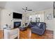 Cozy living room features fireplace, ceiling fan, hardwood floors, and comfortable sectional sofa at 6645 Allness Glen Ln, Charlotte, NC 28269
