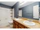 Well-lit bathroom featuring double sinks, a large mirror, and a shower-tub combination at 707 Sinclair Dr, Monroe, NC 28112