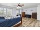 Spacious bedroom with neutral walls, ceiling fan, natural light, wood-look flooring and stylish furnishings at 707 Sinclair Dr, Monroe, NC 28112