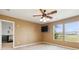 Cozy bedroom featuring a ceiling fan, ample natural light, with an attached bedroom at 707 Sinclair Dr, Monroe, NC 28112