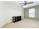 Bright bedroom with neutral carpet, closet space, and natural light from the window at 707 Sinclair Dr, Monroe, NC 28112