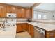 The kitchen includes tile flooring, wood cabinets and a stainless steel dishwasher at 707 Sinclair Dr, Monroe, NC 28112