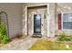 Close-up of the front door and entrance with decorative plants and exterior light fixture at 707 Sinclair Dr, Monroe, NC 28112