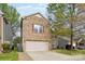Charming two-story home with brick and vinyl siding, showcasing a well-maintained front yard and a two-car garage at 707 Sinclair Dr, Monroe, NC 28112