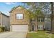 Charming two-story home with brick and vinyl siding, showcasing a well-maintained front yard and a two-car garage at 707 Sinclair Dr, Monroe, NC 28112