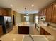 Kitchen view showing island, stainless steel appliances and tile flooring at 707 Sinclair Dr, Monroe, NC 28112