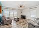 Bright living room features wood-look floors, a ceiling fan, and comfortable seating at 707 Sinclair Dr, Monroe, NC 28112