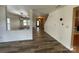 View of the open living room with wood flooring and access to the stairway at 707 Sinclair Dr, Monroe, NC 28112