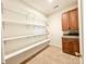 Well-lit pantry features built-in shelving and cabinetry for optimal storage and organization at 707 Sinclair Dr, Monroe, NC 28112