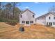 Spacious backyard with a newly built house, featuring a patio, a large lawn, and a wooded area at 7444 Malabar Rd # 14, Huntersville, NC 28078