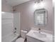 Bathroom with white tile, a white vanity with a quartz countertop, and a stylish octagonal mirror at 7444 Malabar Rd # 14, Huntersville, NC 28078