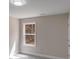 Sunlit bedroom showcasing a large window with peaceful outdoor views and neutral-toned walls at 7444 Malabar Rd # 14, Huntersville, NC 28078