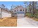 Two story home with light blue and gray siding, concrete driveway, and attached two car garage at 7444 Malabar Rd # 14, Huntersville, NC 28078