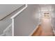 Hallway featuring wood floors and white staircase leading to the second floor at 7444 Malabar Rd # 14, Huntersville, NC 28078