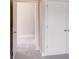Hallway view with neutral walls and carpet, showing the doorway to a bedroom with a double door closet at 7444 Malabar Rd # 14, Huntersville, NC 28078