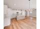 Open floor plan featuring white cabinets, island, stainless appliances, recessed lighting, and wood floors at 7444 Malabar Rd # 14, Huntersville, NC 28078